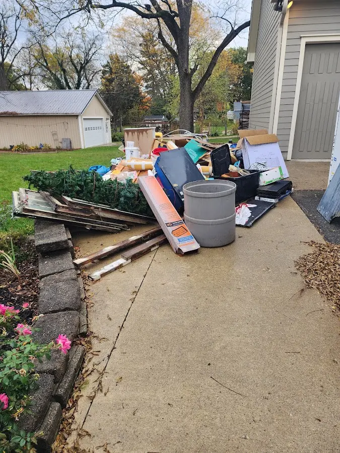 Dumpster being loaded with debris for Roofing Dumpster Rental in Foothill Farms
